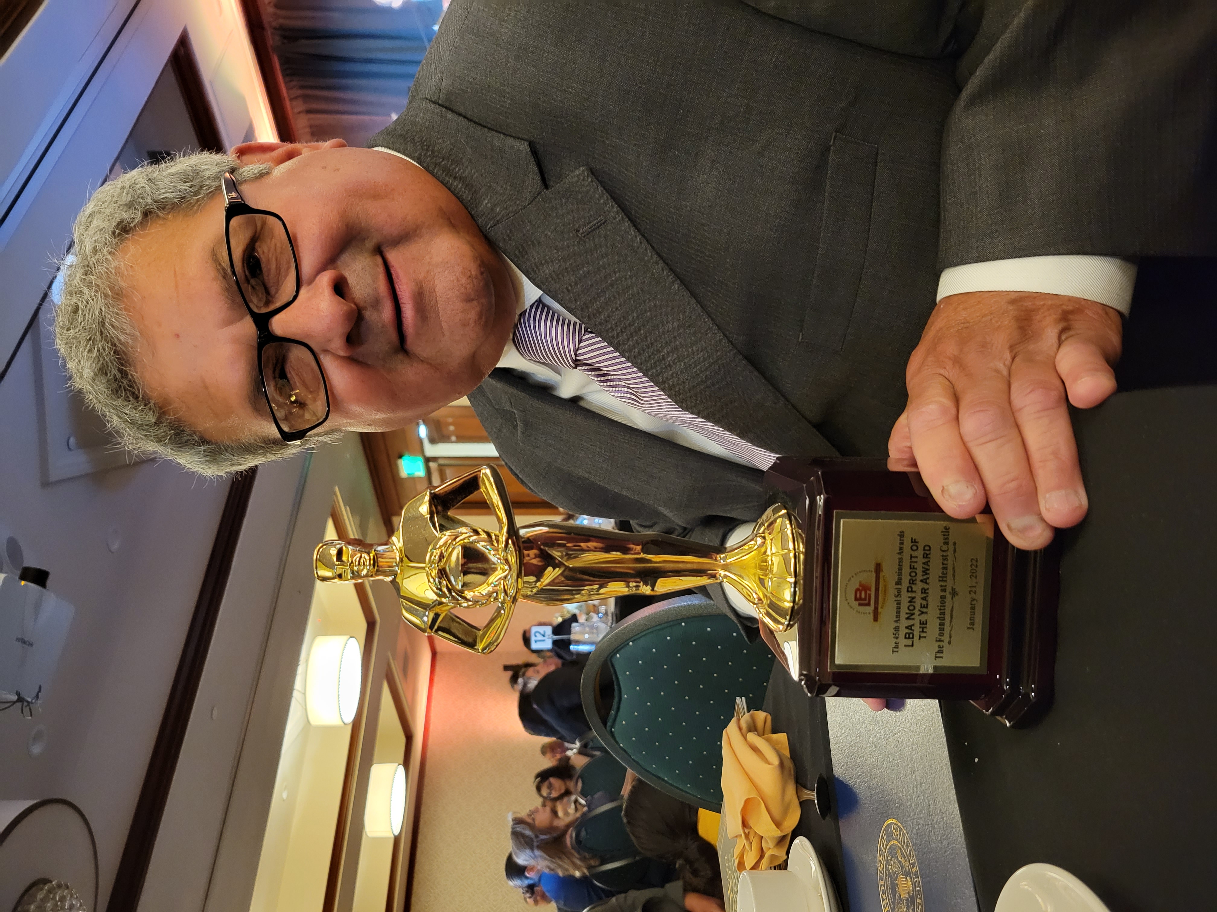 President of the Board Abe Marquez hold the award for "Nonprofit of the Year."